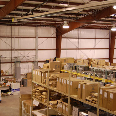 Warehouse heaters mounted above inventory storage racks